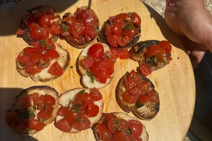 Bruschetta con tomates frescos y albahaca servida en una tabla de madera